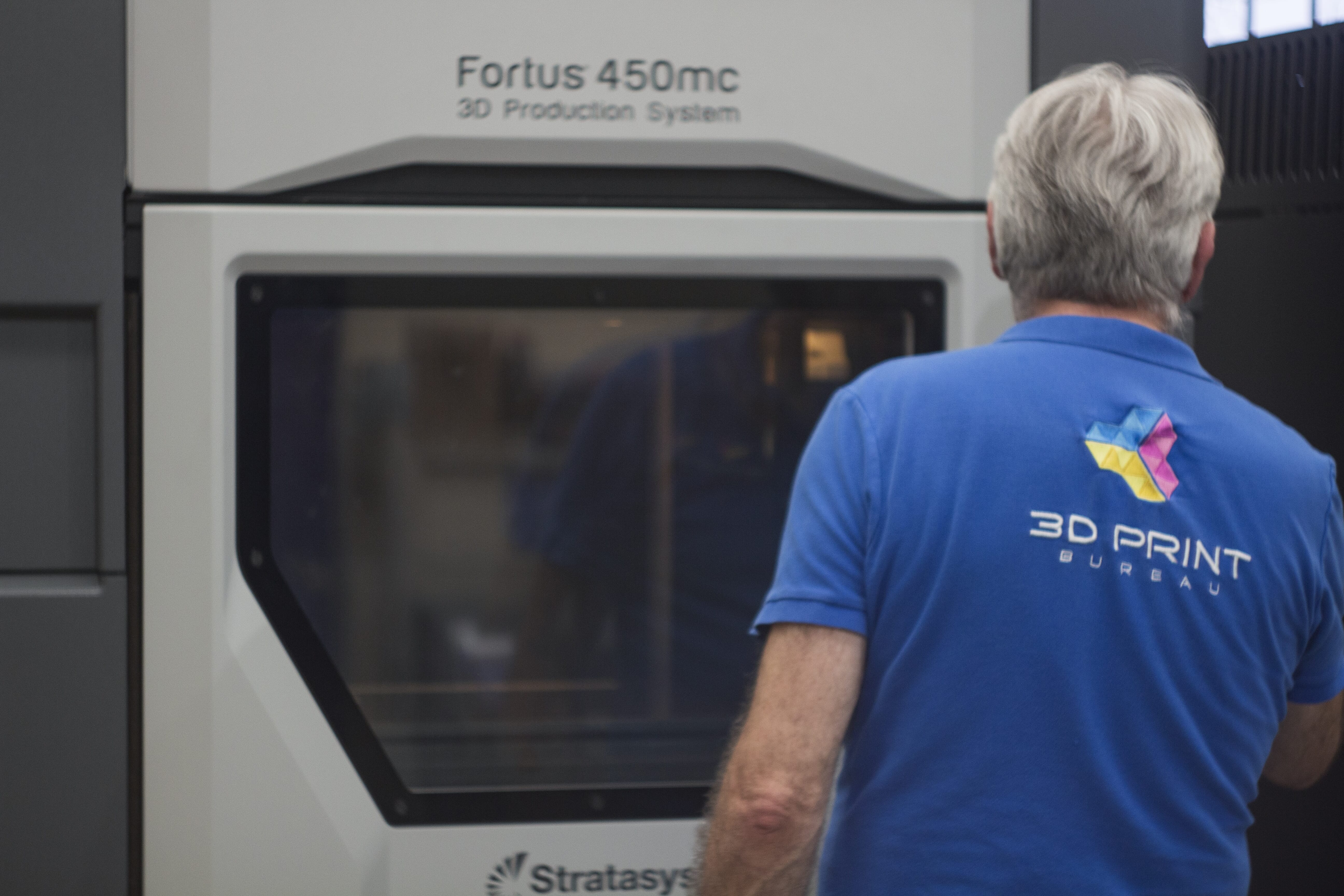 person in front of fortus 450mc printer